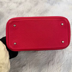 Dior's classic fuchsia pebbled leather can be carried by hand, crossbody, or over the shoulder.