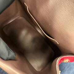 Dior's classic fuchsia pebbled leather can be carried by hand, crossbody, or over the shoulder.